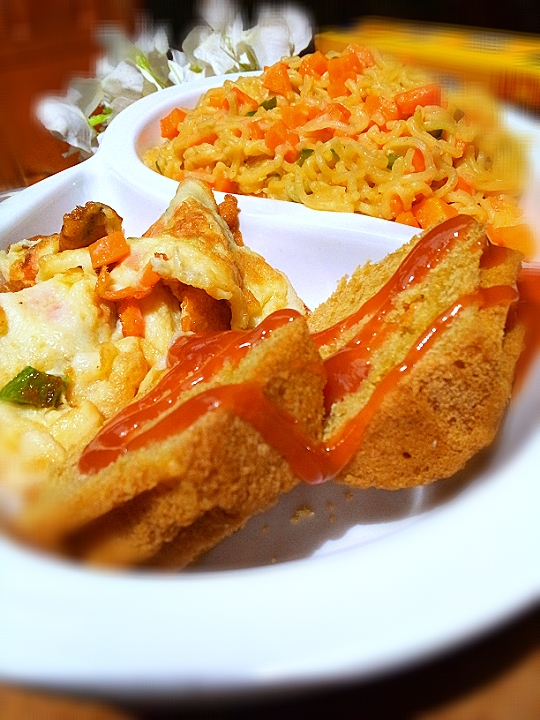 English breakfast of noodles and scrambled egg with cakes