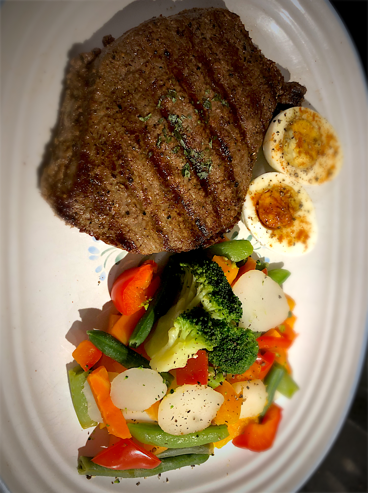 BentoFox's dish Keg Montreal steak seasoned steak, with a side of mixed vegetables and a pickled egg topped with paprika