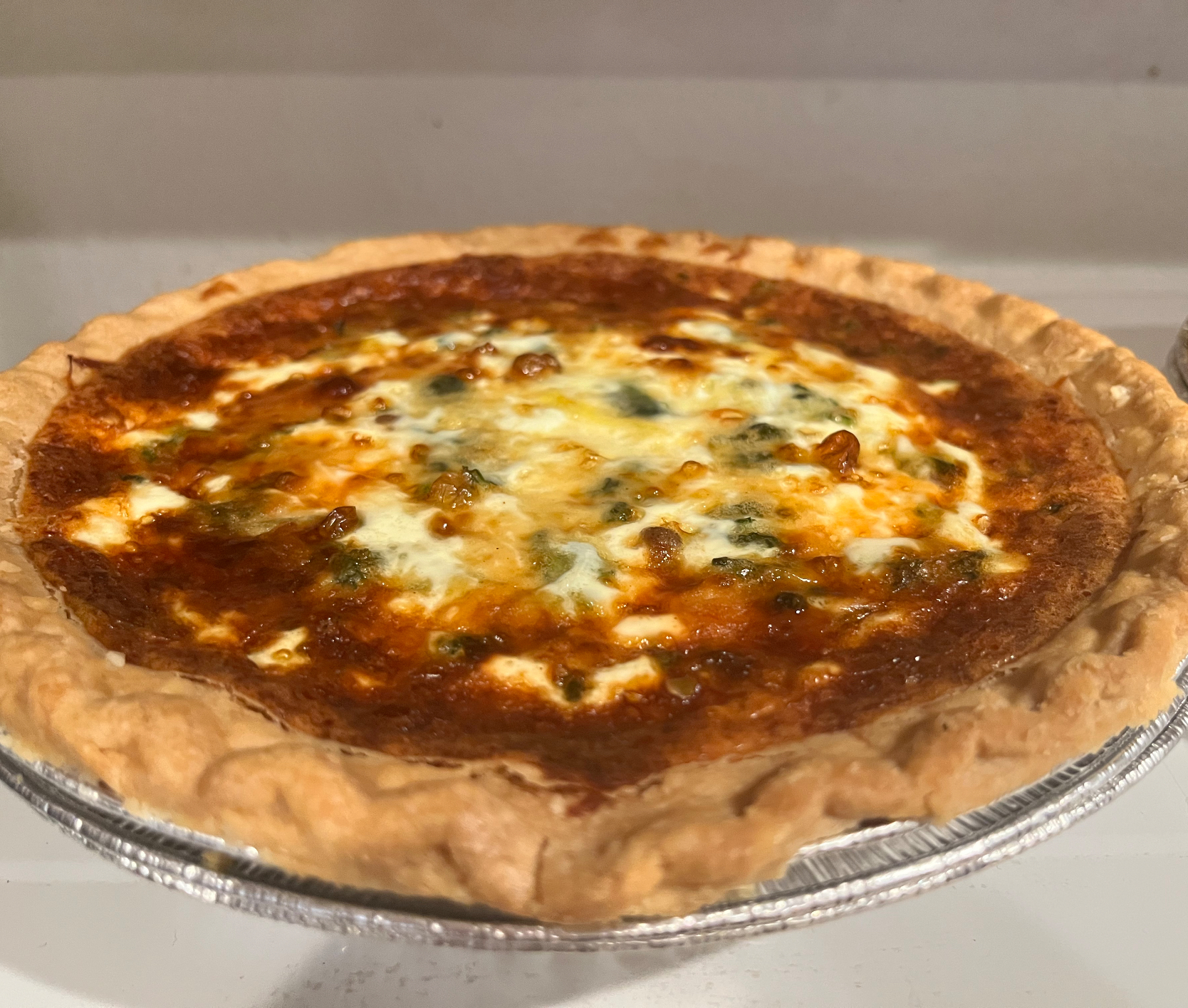 Quiche Lorraine- bacon, caramelized onions, spinach, eggs, heavy cream, and Gruyère cheese